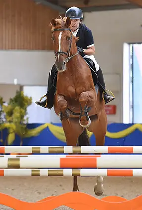 Jacques Pailloncy springt mit einem Pferd gerade über ein Hindernis